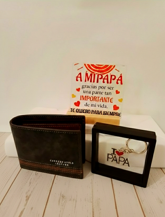 Pack de regalo para papá con cartera negra con raya marrón horizontal, llavero I Love Papa y placa decorativa con mensaje de dia del padre sobre fondo blanco de madrea.