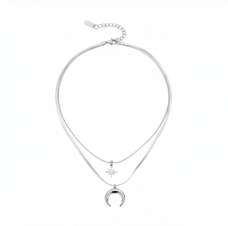 Colgante de Acero de doble cadena, en una de las cadenas cuelga una estrella y en la otra una luna creciente.